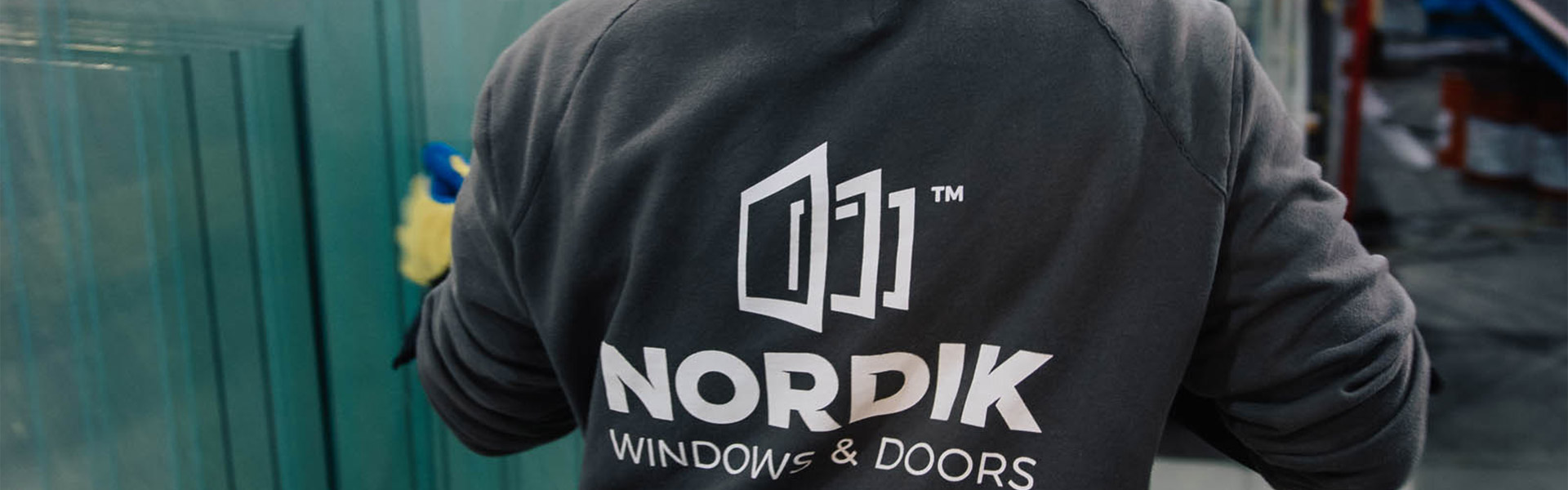 A Nordik window manufacturer looks through window panes to create a thermo for a replacement window.