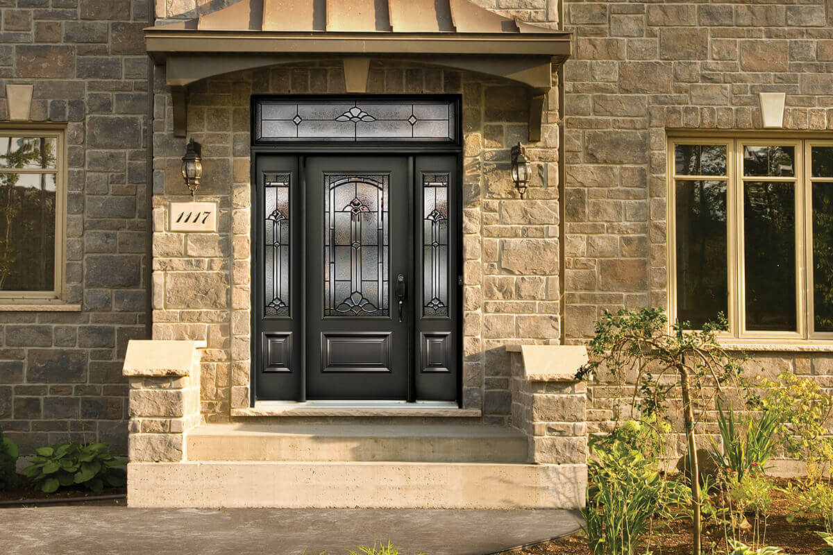 A front entry door with sidelites, an insert and a transom.