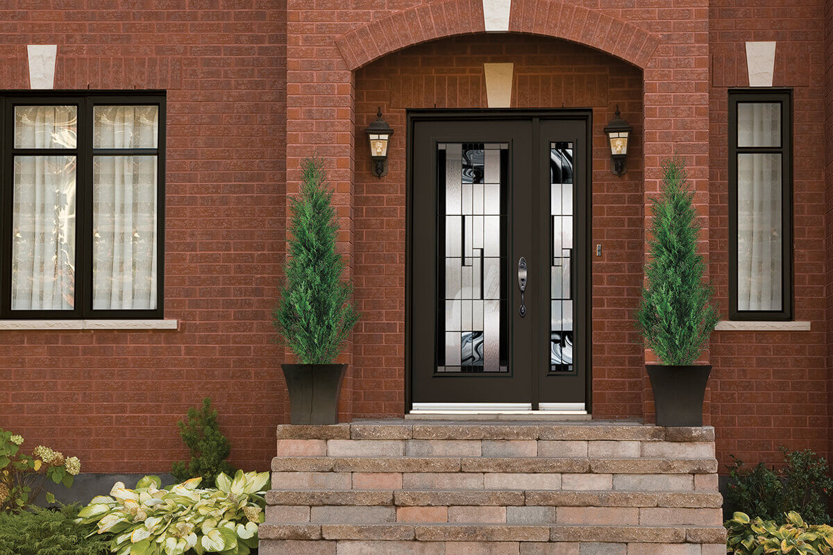 A steel entry door with a sidelite and glass insert.