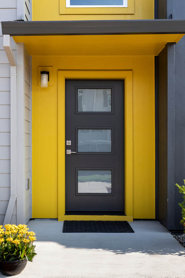 A grey entry door with Acid etched glass inserts on a Flat door slab.