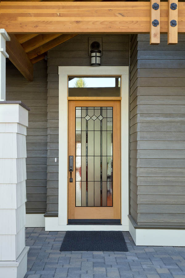 A beige entry door with Auburn glass inserts on a fibreglass door slab.