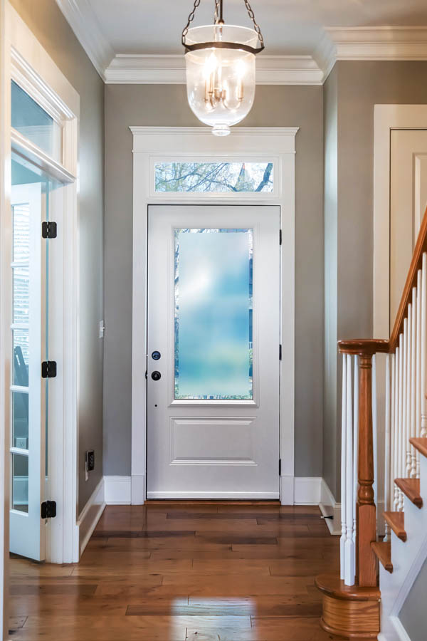 A beautiful white entry door with Clear-Border glass inserts on an Orleans door slab.