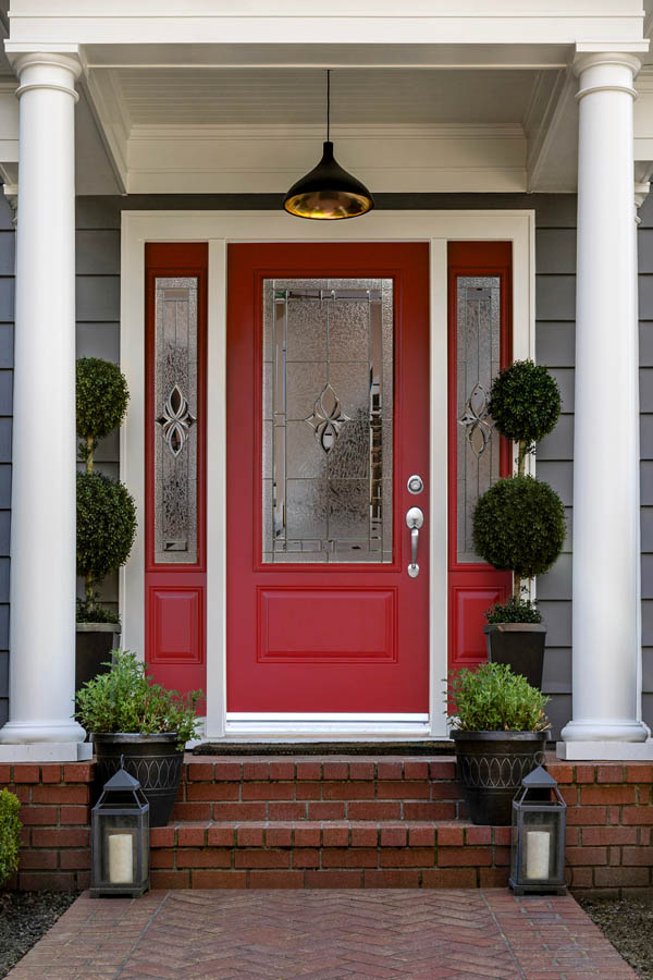 A lovely red entry door with Niagara glass inserts on an Orleans door slab.