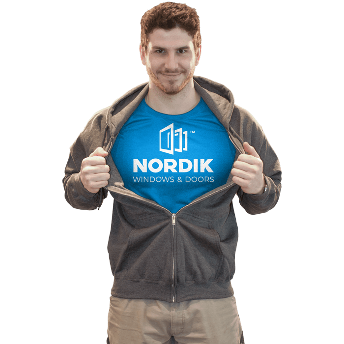 A superman-esque pose from a man wearing a Nordik Windows and Doors shirt.
