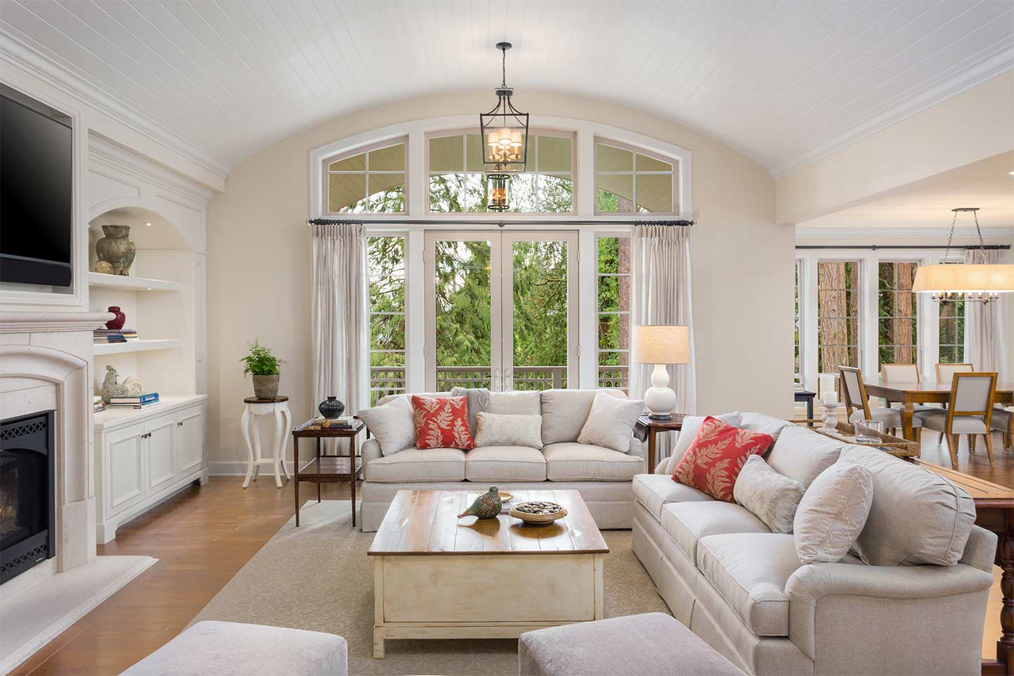 gorgeous French door flanked by two sidelites and an arched transom providing an expansive view to a beautiful garden
