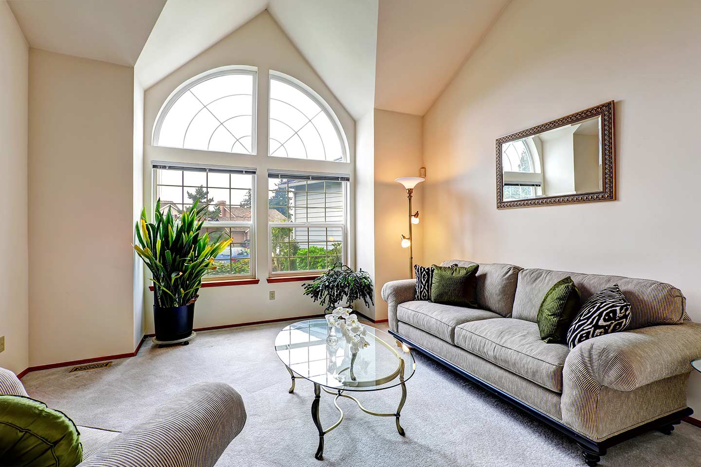 two quarter-round windows above two hung windows in a living room